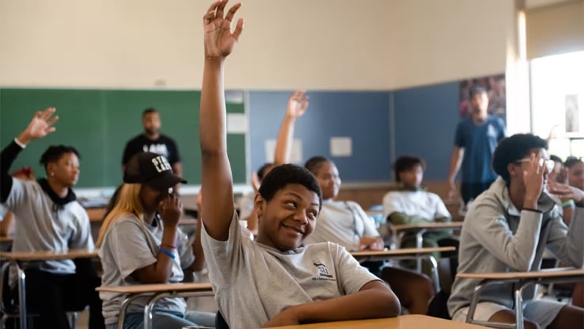 Students in the classroom sitting at desks engaged in activity